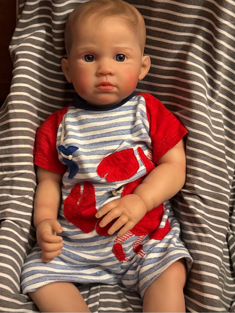 Realistic Baby Doll in Striped Red & Blue Outfit